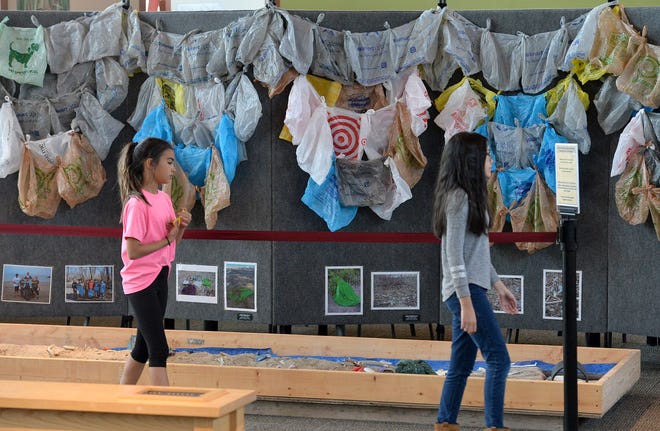 Hannah Coletta, at left, then 10, of Erie, and Jessica Cooper, at right, then 11, of Jacksonville, North Carolina look over an exhibit at the Tom Ridge Environmental Center in Millcreek Township on June 13, 2018. The exhibit, which featured hundreds of plastic bags and was called "Plastic Pollution Solution: One Small Change," highlighted the effects on humans, wildlife and the environment caused by plastic pollution in Lake Erie and other local waters.