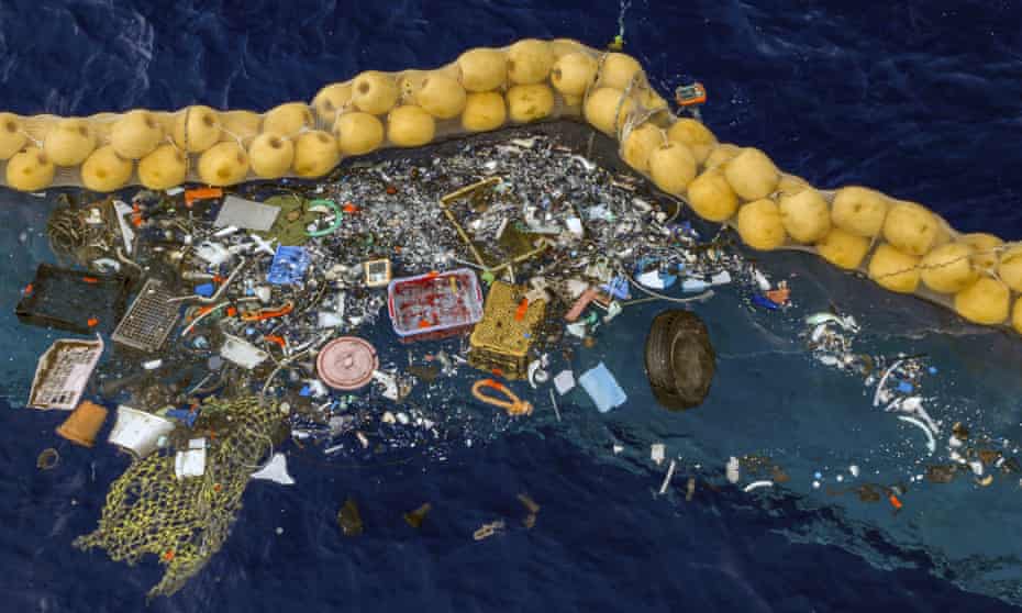 Plastic retained in front of an extended cork line put in by The Ocean Cleanup.