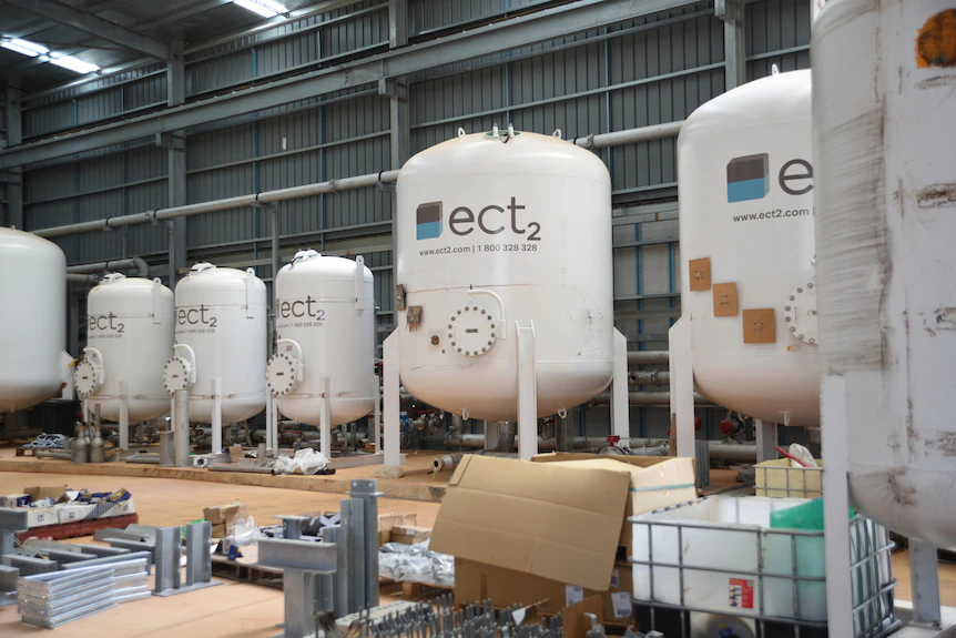 A row of pressure vessels inside a water treatment plant.