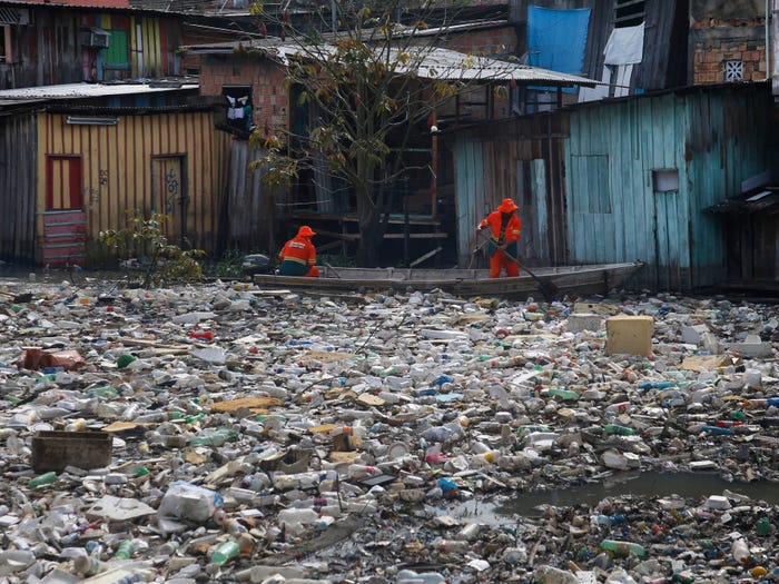Workers remove garbage from Brazil's Negro River