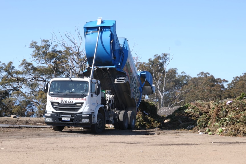 A FOGO truck unloading organic waste at a composting facility
