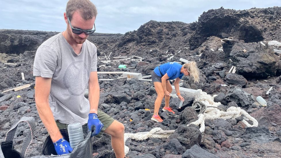 two conservationists helping to clean the coast.