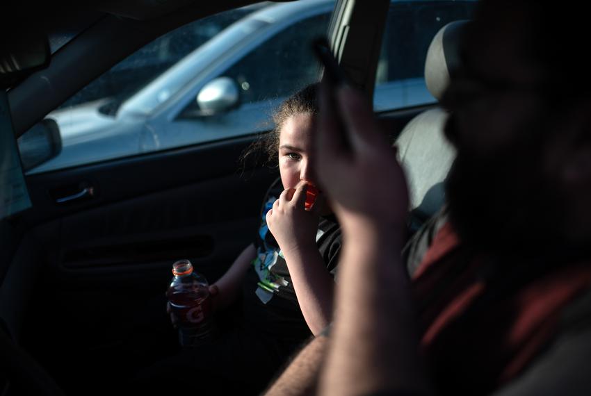 Mario Ochoa and his son Castiel Winchester sit in the car after a day of walking through Hermann Park in Houston on Feb. 25. Four years after the 2019 chemical fire, Ochoa’s now 8-year-old son struggles with sinus infections and is more wary than he once was of playing outdoors.