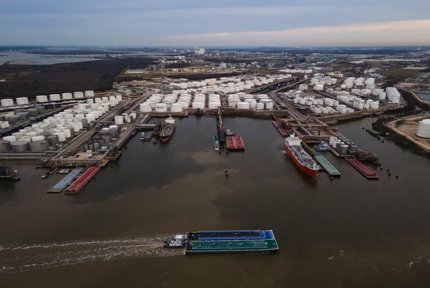 Barges float through the Houston Ship Channel’s murky waters next to the ITC facility on February 13, 2023 in Deer Park, Texas.