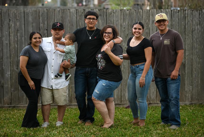 Eddie Guevara (second from the left) and his family in the backyard of their home in Pasadena, Texas, on February 21, 2023. The petrochemical industry has been good to Eddie, but he has always been aware of its dangers. “I always took being clean seriously,” he said, “especially working at a chemical plant where you could potentially carry these hazardous substances with you.”