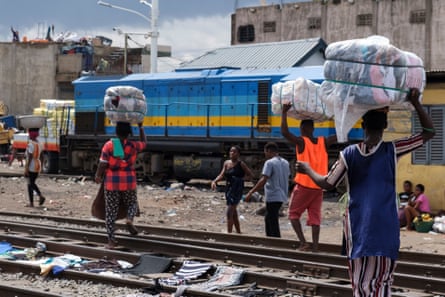 Traders carrying their bales of clothes to Kantamanto market