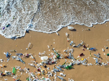 Plastic pollution washes up on a beach.