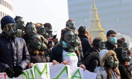 Activists hold a protest to raise awareness about air pollution in Skopje in December 2013
